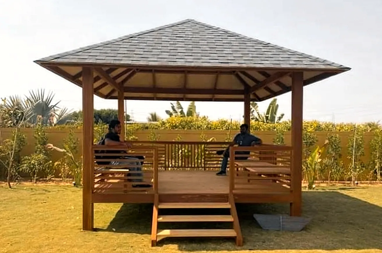 Pine gazebo with shingle roof on a lawn