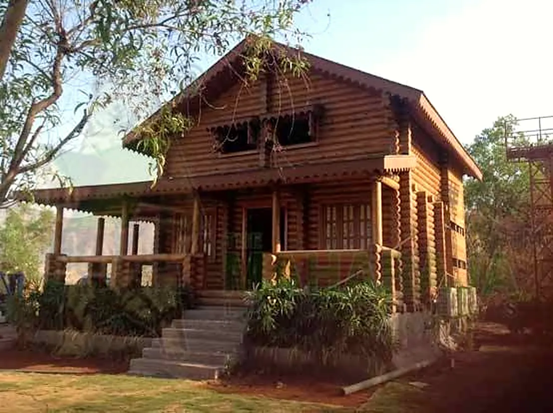Two-storey round-log cabin with porch